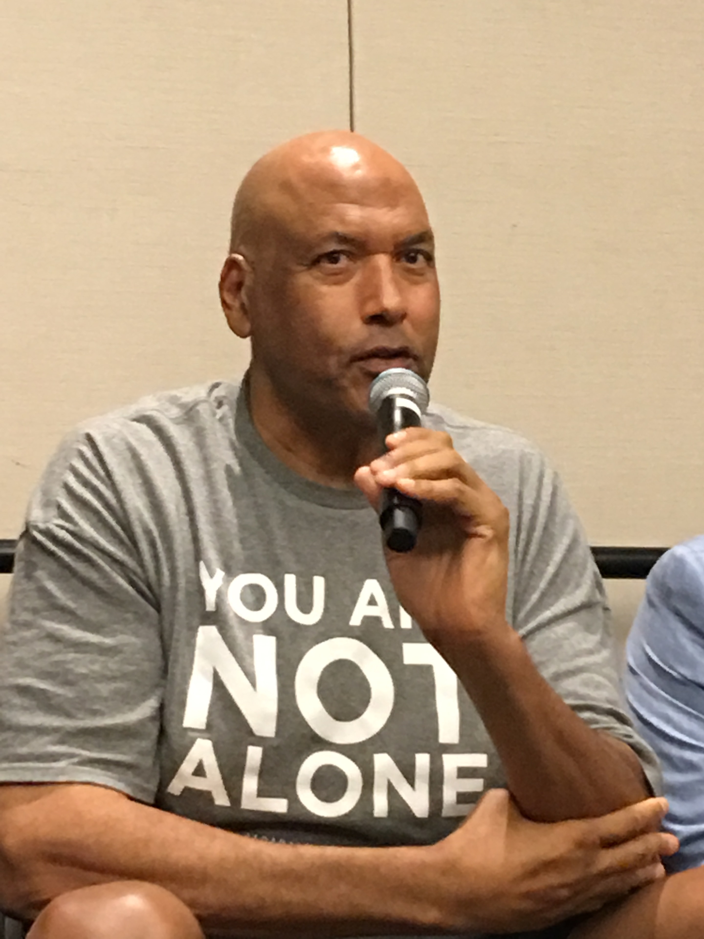 James Donaldson wearing a You Are Not Alone shirt